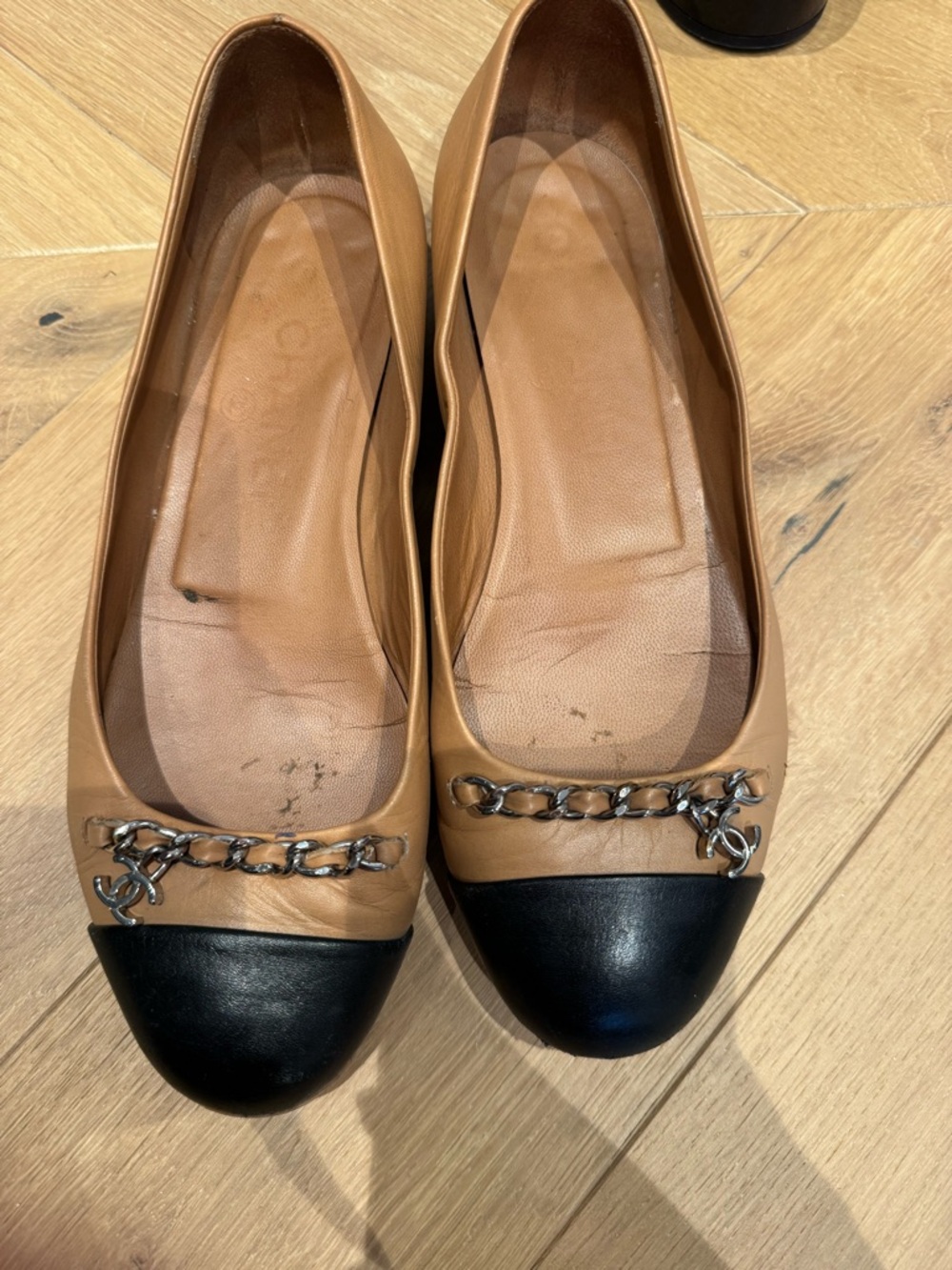 CHANEL Two-Tone Leather Cap-Toe Ballet Flats in Tan and Black with Chain